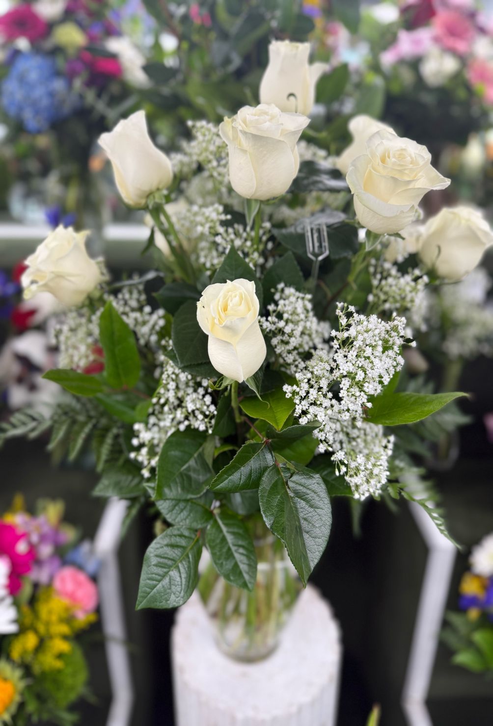 DOZEN WHITE ROSES IN THE COOLER