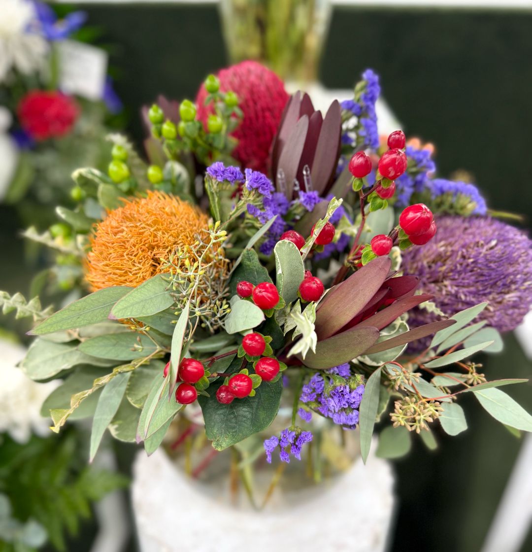 COLORFUL PROTEA ARRANGEMENT IN THE COOLER