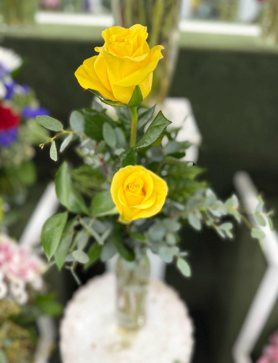 DOUBLE YELLOW ROSE BUDVASE ARRANGEMENT IN THE COOLER
