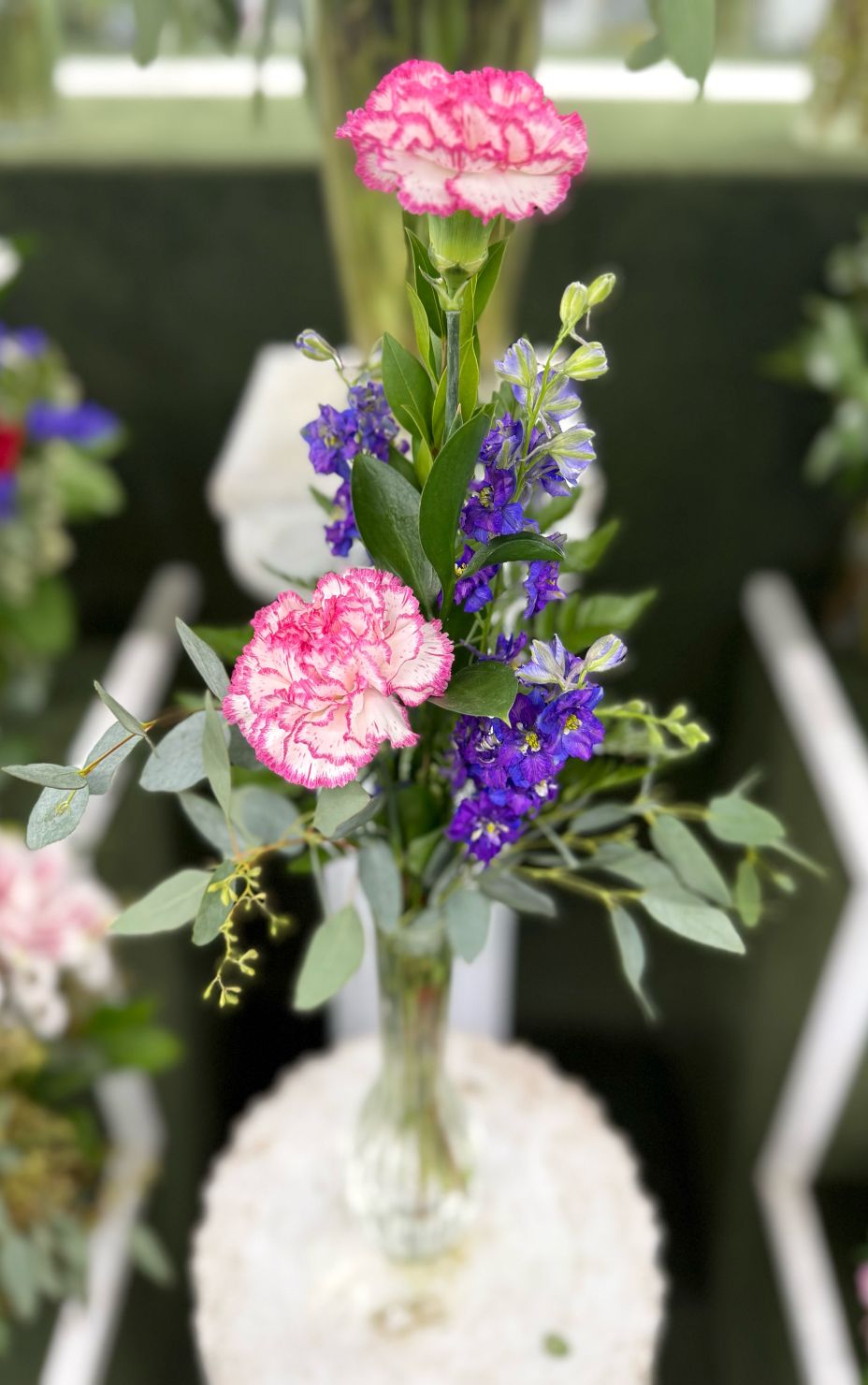DOUBLE CARNATION BUDVASE ARRANGEMENT IN THE COOLER
