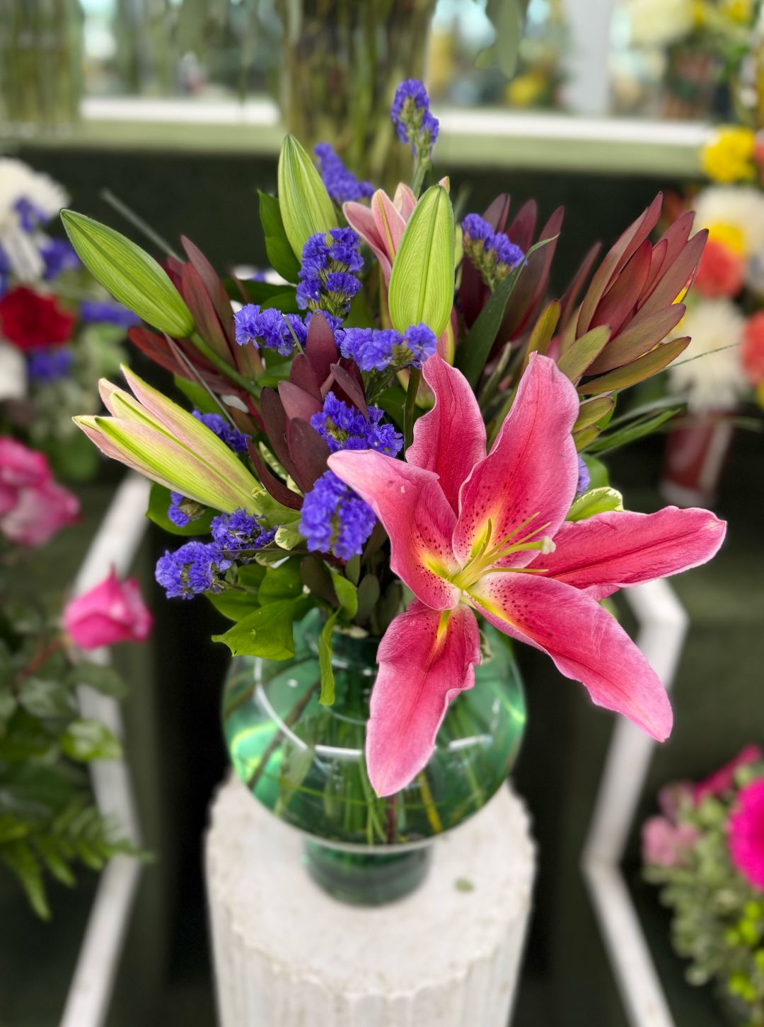 LILY AND SAFARI SUNSET ARRANGEMENT IN THE COOLER