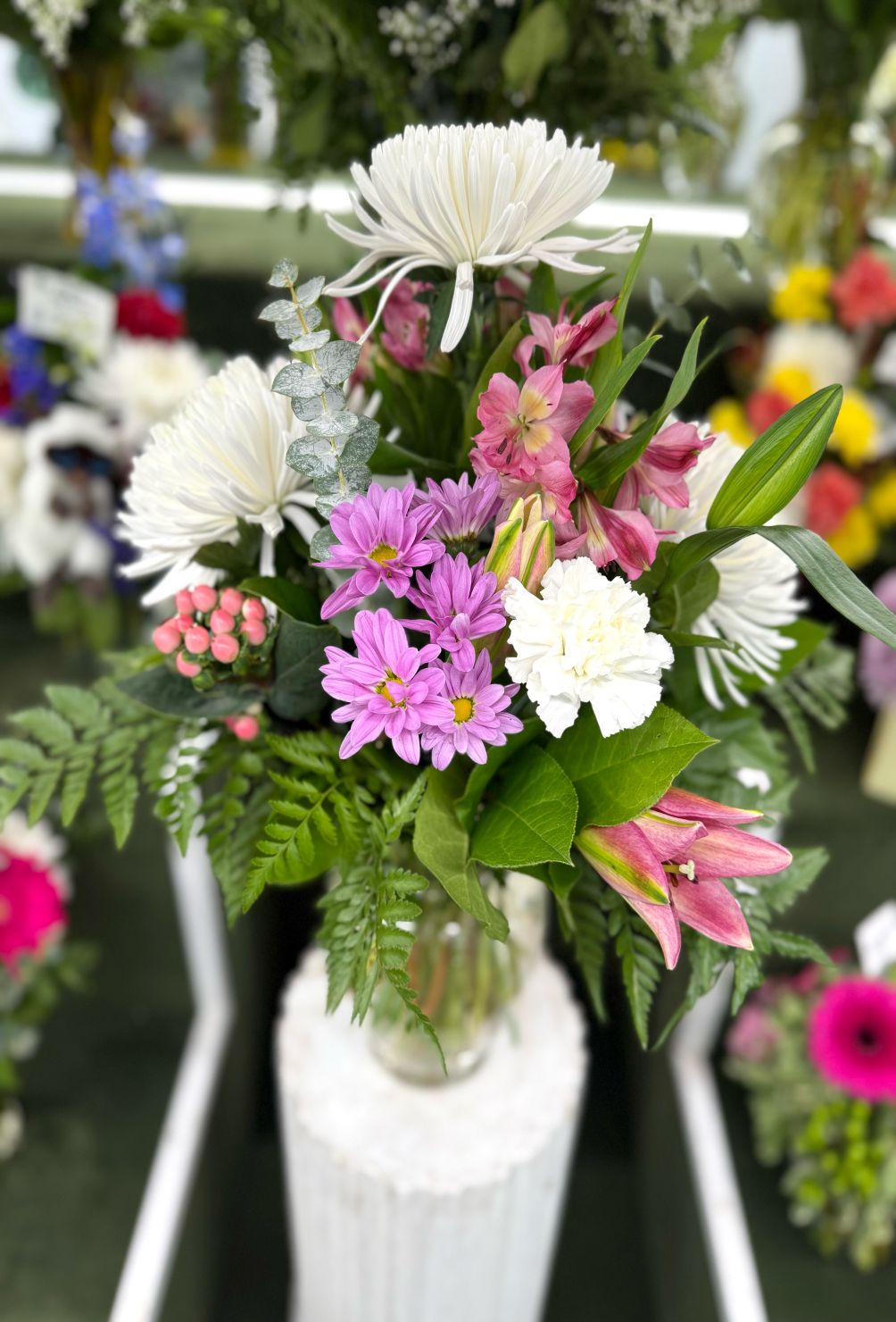 MIX OF WHITE AND PURPLE ARRANGEMENT IN THE COOLER