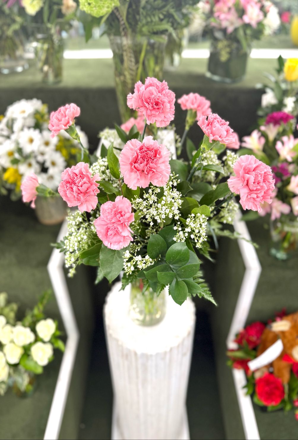 Dozen Pink Carnation Arrangement In the Cooler