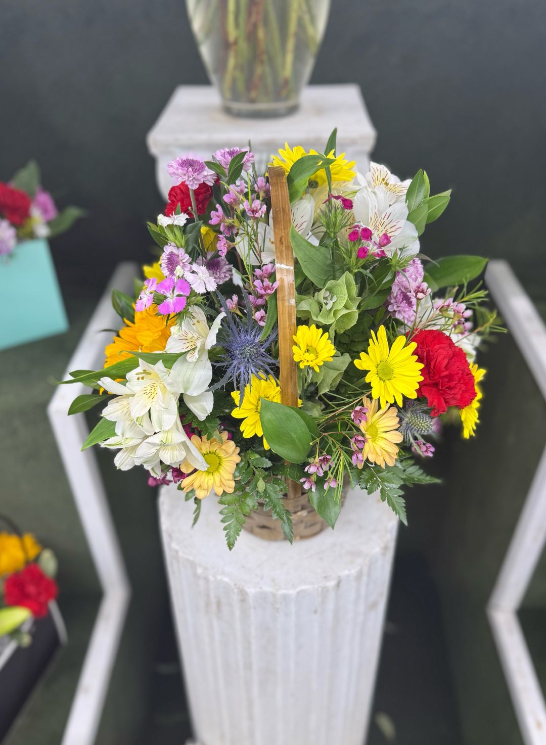 Bundle Of Blooms Basket Arrangement In the Cooler