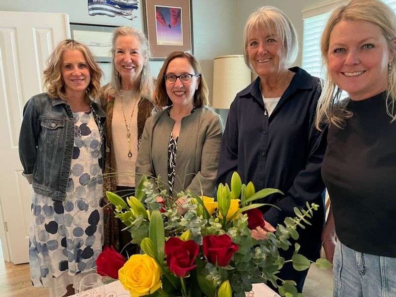 Alpha Gamma Delta Alumnae with Floral Arrangement