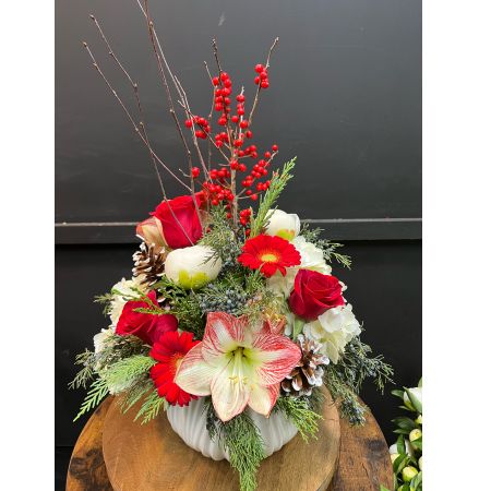 Colony Florist & Gifts Franklin Lakes - White ceramic dish filled with holiday greenery, hydrangea, roses, peonies, gerbera, amaryllis, juniper, ilex berries & pine cones. 