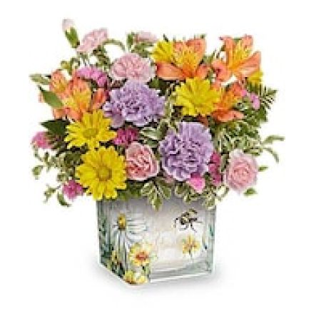My Lady's Florist Westland - Like a bee dancing through a hidden garden, this enchanting bouquet of orange, lavender, and yellow blooms in a vintage-inspired glass cube makes for a truly magical gift.