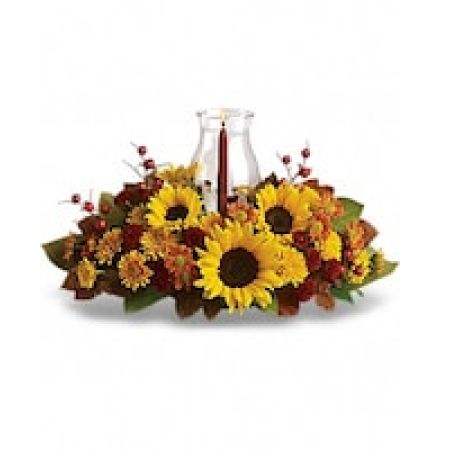 My Lady's Florist Westland - Symbolizing warmth and happiness, it is no wonder the sunflower is a quintessential ingredient in so many fall bouquets. This centerpiece maximizes the joy of sunflowers by arranging them with a bevy of fall flowers, foliage and a cranberry hued candle under hurricane glass.