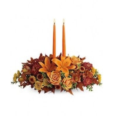 My Lady's Florist Westland - As your loved ones gather around the table, they'll bask in the warm glow of two orange taper candles surrounded by a fantastic array of fall flowers.
