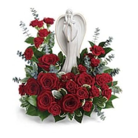 My Lady's Florist Westland - This peaceful porcelain angel sculpture, surrounded by radiant red roses and delicate greenery, is a touching tribute to a rich life.\n