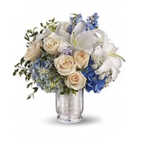 My Lady's Florist Westland - Spend a peaceful afternoon at the seaside with this breathtaking centerpiece. Lush blue hydrangea and delphinium evoke sea and sky, while creamy roses, white lilies and delicate Queen Anne's lace whisper of sand and sea foam. Presented in an antiqued Mercury Glass Vase, it's an elegant choice for weddings and showers.