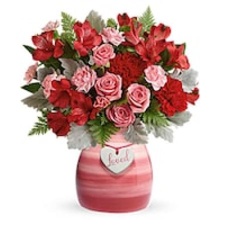 My Lady's Florist Westland - Make that special someone smile with this beloved bouquet! Playful pink roses and radiant red carnations and alstroemeria look oh-so wonderful in this hand-painted pink ceramic vase, adorned with a charming \