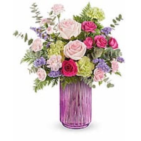 My Lady's Florist Westland - Embrace the enchanting colors of spring with this bouquet of pink, lavender, and vibrant green blooms, presented in a striking pink lantern that shines beautifully in the light.