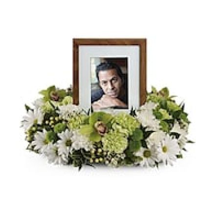 My Lady's Florist Westland - An exquisite round wreath with blooms inspired by the lasting impressions a loved one makes on our lives. Surround a treasured photograph, poem or other dear memento with sweet, green carnations, white and green chrysanthemums and the special beauty of green cymbidium orchids.