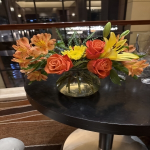 Dottie's Flowers and Plants Los Angeles - Brighten any space with this radiant bouquet of roses, lilies, alstroemeria, and chrysanthemums, a symphony of warm orange and sunny yellow hues. The captivating fragrance and vibrant colors evoke feelings of joy and optimism, perfect for celebrations or simply to uplift the everyday. Delivered in a charming glass vase, this fresh flower arrangement makes a thoughtful gift for any occasion – birthdays, anniversaries, or just because. Send a burst of sunshine and heartfelt emotion with this stunning floral display.