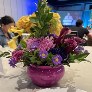Dottie's Flowers and Plants Los Angeles - Radiant sunflowers and lilies burst with sunshine, balanced by the rich jewel tones of purple asters and calla lilies in a stunning, vibrant display. This cheerful **flower arrangement** brings a touch of modern elegance to any space, perfect for brightening a home or celebrating a special occasion. Delivered in a striking fuchsia vase, it’s a unique **floral gift** that expresses joy and thoughtfulness. Send a burst of color and fragrant beauty with this unforgettable **bouquet** – guaranteed to lift spirits and create lasting memories.