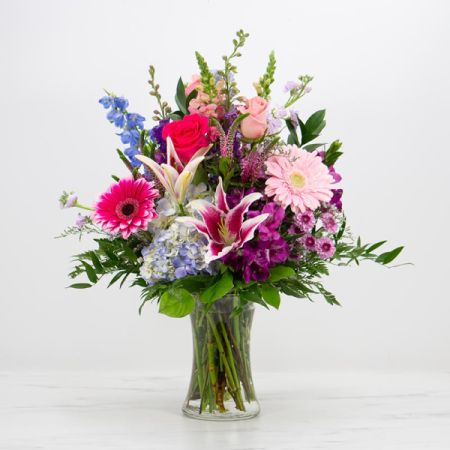 Beaverton Florists- Demo Beaverton - Shades of pink, purple, and bright blue make this cheerful arrangement pop. Displayed in a classic glass vase, Ultra Violet has the height and charm to make a big statement!

Size: 17 x 17 x 24

STEMS INCLUDED:
Delphinium
 | 
Gerberas
 | 
Hydrangeas
 | 
Roses
 | 
Snapdragons
 | 
Tulips
 | 
Alstroemeria
 | 
Poms
 | 
Stock