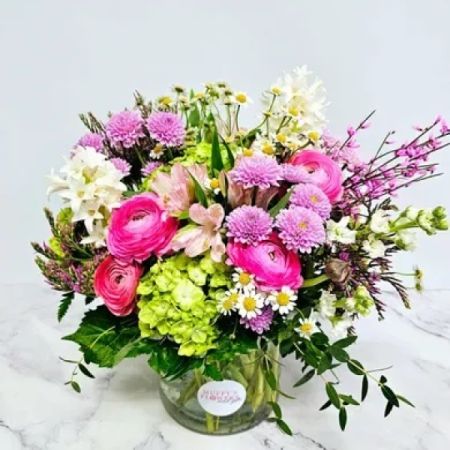 Beaverton Florists- Demo Beaverton - A delightful spring-inspired arrangement featuring Pink Ranunculus, luxurious Hydrangea, fragrant Chamomile, and Hyacinth, harmoniously intertwined in a whimsical design that captures the essence of the season's beauty.