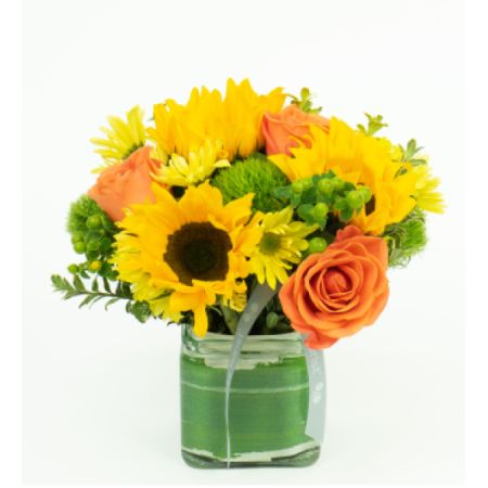 Beaverton Florists- Demo Beaverton - A vibrant burst of sunshine! This cheerful arrangement features golden sunflowers, soft peach roses, and delicate chrysanthemums, all nestled amongst lush greenery. Presented in a square glass vase with a light green ribbon, 'Citrus' is guaranteed to brighten any space and lift spirits. It’s a joyful and refreshing gift for any occasion.