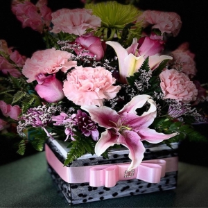 Almy's Florist San Bernardino - Immerse yourself in the breathtaking beauty of 'Lilies Galore' a stunning arrangement designed to evoke pure joy and sophisticated elegance. A cascade of fragrant lilies unfolds in a harmonious blend of shapes and textures creating a visual masterpiece that breathes life into any space. Imagine this bouquet gracing your dining table transforming a simple meal into a special occasion or sending a heartfelt message of love sympathy or celebration to someone dear. The delicate petals feel like silk and the subtle perfume fills the air with a sweet captivating scent. ‘Lilies Galore’ is more than just flowers; it's an experience—a touch of nature’s artistry to brighten any day.