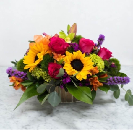GotFlowers Demo Westland - Bring the warmth of a summer afternoon indoors with Sunlit Meadow. This exquisite arrangement bursts with the joyful energy of freshly-picked blossoms reminiscent of rambling walks through sun-drenched fields. Delicate textures and a harmonious blend of color create a sense of relaxed elegance – perfect for brightening a home expressing heartfelt gratitude or simply treating yourself to a little bit of happiness. Imagine the soft glow of this bouquet adorning a dining table infusing any space with a cheerful and inviting ambiance. This stunning floral design is a beautiful gift for birthdays anniversaries or just because.