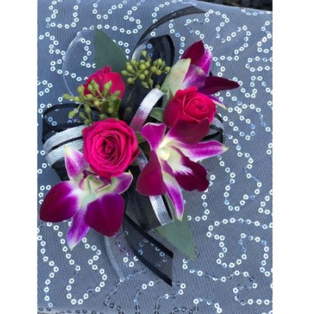 Flowers By Fairytales Elk Grove - This corsage has roses and orchids. Customers may choose the colors of the flowers and ribbon.