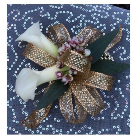 Flowers By Fairytales Elk Grove - A stunning corsage with calla lilies and wax flower. Customers may choose the color of the ribbon.