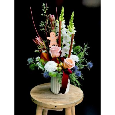 Fortin Gage Nashua - This arrangement has it all! Velvet ribbon, gold accent decor, roses, Christmas greens and a cute gingerbread man! 