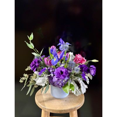 Fortin Gage Nashua - A daydream come true in an arrangement of lush flowers. Promises of spring with tulips and iris complement the promise of love in deep purple roses. The soft dusty miller soothes the senses bringing about a daydream. 