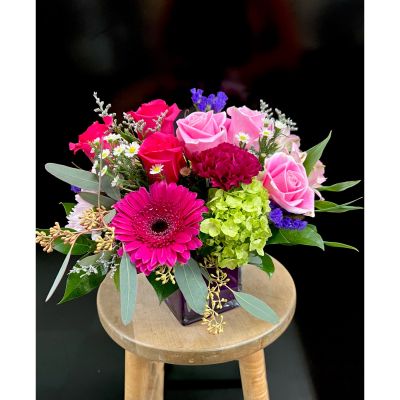 Fortin Gage Nashua - Boasting brilliant hot pink blossoms, each petal is meticulously arranged to create a stunning display of floral elegance. Delivered in an exclusive gem-tone purple vase, this bouquet is not only a feast for the eyes but also a unique and sophisticated statement piece. With our commitment to prompt service, take advantage of our same-day flower delivery option to ensure this exquisitely beautiful bouquet promptly graces the recipient with its vibrant charm, creating a moment of joy and admiration.