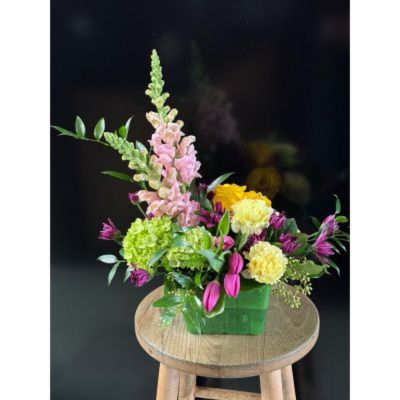Fortin Gage Nashua - We are so ready for spring! This sweet arrangement in a berry basket features tulips, snap dragons and more