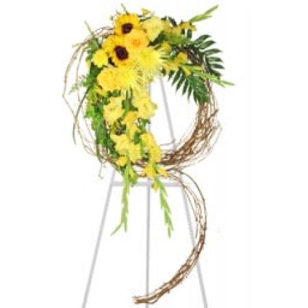 Madison Avenue Florist Sacramento - The "Sunshine of Life" Sympathy Wreath is a beautiful and radiant standing spray, carefully crafted to bring warmth and comfort during a difficult time. The wreath features a cascade of vibrant and sunny bright flowers, symbolizing the light and positivity that the departed brought into the lives of others. The flowers are elegantly arranged on a cascading grapevine, creating a stunning visual tribute. This sympathy wreath serves as a heartfelt expression of love, support, and remembrance, offering solace to those mourning the loss of a loved one. Placed at the memorial service, it becomes a symbol of the enduring impact of a life well-lived and the everlasting beauty of cherished memories.





