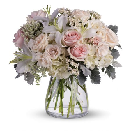 Madison Avenue Florist Sacramento - Embrace the Beautiful Whisper of love with this whisper-quiet affirmation. Subtle shadings of pink and white roses, lilies, and delicate Queen Anne's lace come together in a simple yet elegant vase. This arrangement features gorgeous flowers such as white, crème, and light pink roses, white oriental lilies, and delicate Queen Anne's lace with a touch of silvery dusty miller, all presented in a classic hurricane vase. Measuring approximately 15 1/2 inches, this bouquet exudes timeless elegance. With our same-day flower delivery, you can effortlessly send the Beautiful Whisper arrangement, allowing the recipient to be enchanted by the delicate beauty of these blooms promptly. It's a perfect choice for expressing love, and admiration, or sending warm wishes on various occasions.