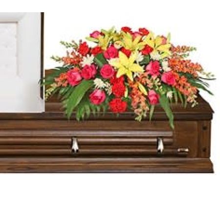 Flowers In Design Sacramento - This is a vibrant display of hot pinks, oranges and corals with pops of bright yellows. For that loved one who lived life out loud! Give them the tribute that was the perfect match for them. Available in one size. Large enough for a closed casket service but not too large for an open lid viewing.
