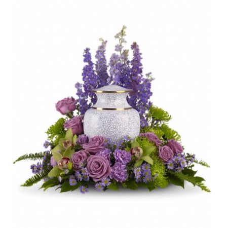 Flowers In Design Sacramento - Create a serene and contemplative atmosphere with our "Meadows of Memories Cremation Tribute." Soft lavender and green blooms elegantly surround the urn, forming a peaceful garden of remembrance. Lavender larkspur, roses, and asters are thoughtfully paired with the rich greens of cymbidium orchids, chrysanthemums, English boxwood, and sword fern. This arrangement, approximately 23 1/2 inches in size, is a heartfelt expression of love and tribute. Please note that the arrangement does not include an urn. THIS DESIGN IS CREATED FOR THE URN SIZE AND DESIGN DEPICTED IN PHOTO. IF YOUR URN IS SHAPED OR SIZED DIFFERENTLY, YOU WILL NEED TO CALL FOR APPROPRIATE PRICING. It serves as a beautiful and comforting way to honor and remember a cherished individual.