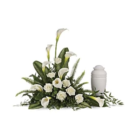 Flowers In Design Sacramento - Create a serene and elegant tribute with our "Stately Lilies" urn spray. This beautiful arrangement features all-white flowers, including graceful calla lilies and white roses, expressing peaceful beauty. The blooms are complemented by rich tropical greenery, including Italian ruscus, salal, calathea leaves, sword fern, and aspidistra leaves. Place this urn spray on a table next to an urn, guest book, or framed photographs for a graceful and heartfelt tribute. Please note that the arrangement does not include an urn but serves as a beautiful expression of sympathy and remembrance.