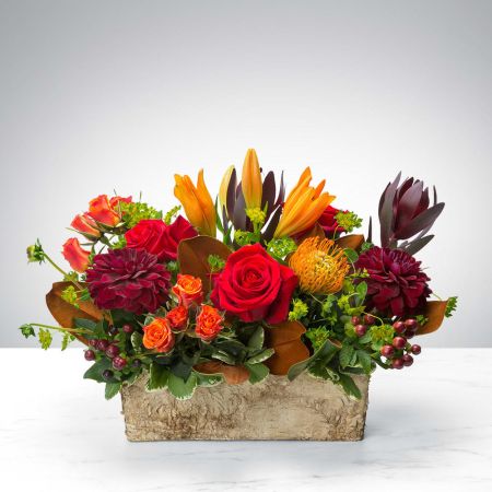 Madison Avenue Florist Sacramento - Experience the convenience of changing seasons with the Box of Autumn by BloomNation. Just like boxed wine and lunches, now autumn comes neatly packaged in a delightful box filled with seasonal blooms. This innovative creation captures the essence of fall's beauty, featuring an abundant arrangement of rich-hued flowers that embody the warmth and charm of the season. Whoever receives this thoughtful gift is sure to smile with seasonal joy, and with our same-day flower delivery, you can effortlessly share the cozy spirit of autumn with your loved ones, making it a uniquely delightful experience.