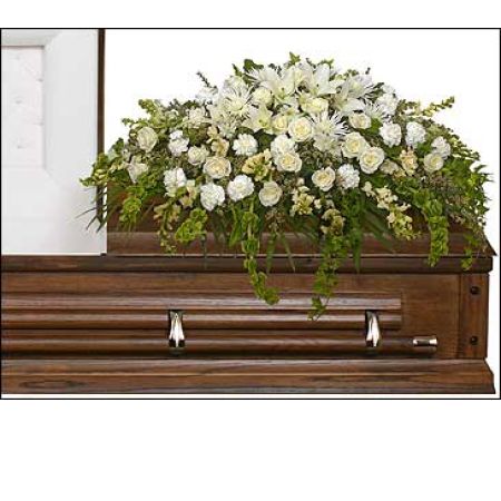 Flowers In Design Sacramento - A beautiful casket spray of all white blossoms of seasonal floral, this does contain roses with stunning draping greenery. As shown in a half casket for open viewing services. This can be designed in a full casket for closed lid services. 