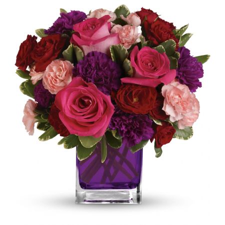 Madison Avenue Florist Sacramento - Pure romance. Hot pink roses and dark red spray roses are brightly arranged inside our violet cube.  Hot pink roses, dark red spray roses, purple carnations and pink miniature carnations are accented with assorted greens. Delivered in Teleflora's glass violet cube.  Approximately 11 1/2\