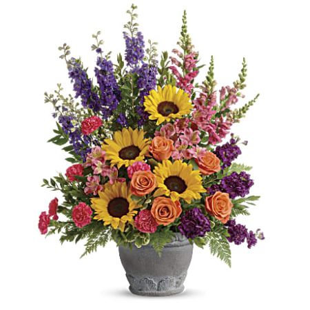 Madison Avenue Florist Sacramento - Send a message of warmth and hope with this magnificent display of sunflowers and roses in a large antiqued pot, a colorful tribute that will warm their hearts. This bright arrangement includes orange roses, pink alstroemeria, hot pink carnations, yellow sunflowers, purple larkspur, purple stock, hot pink snapdragons, myrtle, variegated pittosporum, and leatherleaf fern.
