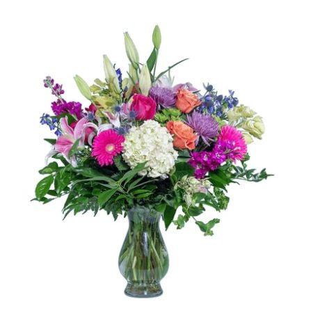Conroy's Florist & Flower Delivery Mission Viejo - They light up your universe. "Love You to the Moon" conveys your deep affection. A pristine white hydrangea holds the central spotlight, surrounded by radiant stargazers, roses, and assorted blossoms, all elegantly presented in our Bella vase