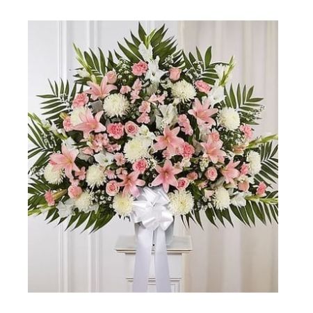 Conroy's Florist & Flower Delivery Mission Viejo - For those who are grieving, a heartfelt gesture can mean so much. Our elegant pink and white standing basket arrangement will honor the memory of a loved one in a beautiful way. Artistically designed with a medley of pink blooms, this touching expression offers comfort and support when it's needed most.

One-sided standing basket arrangement with pink roses, Asiatic lilies, Peruvian lilies (alstroemeria) and carnations, white gladiola, football mums and monte casino; accented with assorted greenery and white bow
Extra large arrangement measures approximately 39&#34;H x 41&#34;W without stand
Large arrangement measures approximately 38&#34;H x 38&#34;W without stand
Medium arrangement measures approximately 32&#34;H x 36&#34;W without stand
Small arrangement measures approximately 30&#34;H x 34&#34;W without stand
Appropriate for the funeral home
Wire stand is based on local availability
Our florists hand-design each arrangement, so colors and varieties may vary due to local availability