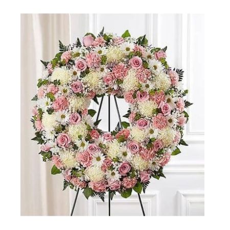 Conroy's Florist & Flower Delivery Mission Viejo - The memories shared with a loved one can help bring serenity after they are gone. Our standing wreath in pink is a lovely way to celebrate those moments. Expertly crafted by our local florists with graceful pink and white blooms for a lush, full presentation, this traditional funeral arrangement is a beautiful way to honor their life.

Standing wreath arrangement with pink roses, carnations and limonium; white football mums and daisy poms; accented with baby's breath and soft, lush greenery
Large arrangement measures approximately 68&#34;H x 33&#34;L with easel
Small arrangement measures approximately 66&#34;H x 31&#34;L with easel
Appropriate for the funeral home
Easel may not be available in all areas
Our florists hand-design each arrangement, so colors and assortment may vary based on local availability