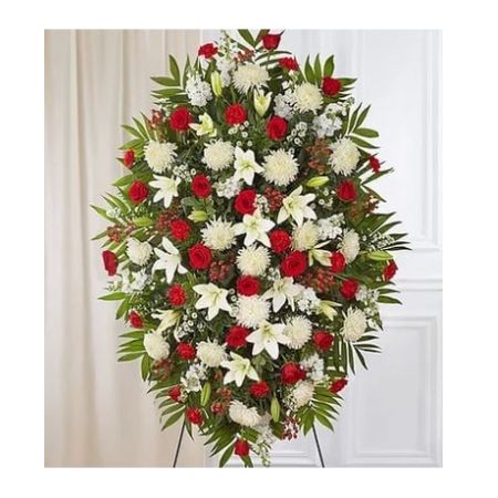 Conroy's Florist & Flower Delivery Mission Viejo - A warm embrace. A kind word. A memorable gesture. There are many ways to express how we feel after the loss of a loved one. Our classic standing spray arrangement is elegantly crafted with radiant red roses and peaceful white blooms, offering care and support when it's needed most.

One-sided standing spray arrangement with red roses, carnations and hypericum, white Asiatic lilies, football mums, stock and monte casino; accented with assorted greenery
Extra large arrangement measures approximately 60&#34;H x 40&#34;W without stand
Large arrangement measures approximately 56&#34;H x 38&#34;W without stand
Medium measures approximately 46&#34;H x 34&#34;W without stand
Small measures approximately 42&#34;H x 30&#34;W without stand
Arrives on an easel
Appropriate for the funeral home or gravesite
Our florists hand-design every arrangement, so colors and varieties may vary due to local availability