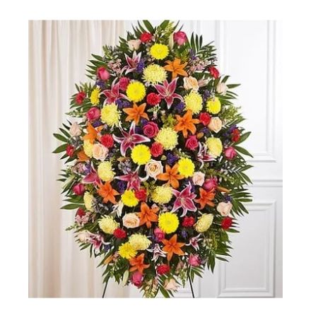 Conroy's Florist & Flower Delivery Mission Viejo - Their passion and joy for life will always be remembered. Our classic standing spray arrangement was designed to capture that colorful spirit. Elegantly crafted for a lush, full presentation, this vibrant mix of blooms creates a memorable tribute to someone who was truly one-of-a-kind.

One-sided standing spray arrangement with red carnations, orange Asiatic lilies, yellow Gerbera daisies and football mums, peach and hot pink roses, pink Stargazer lilies and snapdragons, purple statice and monte casino; accented with assorted greenery
Extra large measures approximately 60&#34;H x 40&#34;W without stand
Large measures approximately 56&#34;H x 38&#34;W without stand
Medium measures approximately 46&#34;H x 34&#34;W without stand
Small measures approximately 42&#34;H x 30&#34;W without stand
Arrives on an easel
Appropriate for the funeral home or gravesite
Our florists hand-design each arrangement, so colors and varieties may vary due to local availability