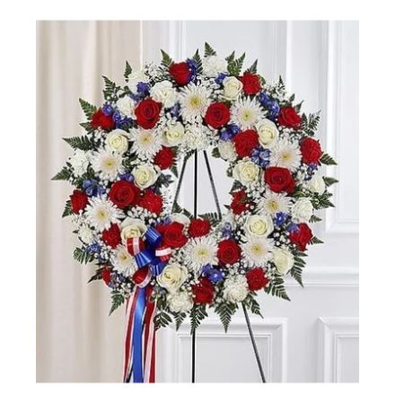Conroy's Florist & Flower Delivery Mission Viejo - They served their country with honor and pride, so it's only fitting to honor them with a beautiful symbol of eternal life. Our patriotic standing wreath arrangement is meticulously crafted by our expert florists to honor a brave veteran who has passed away. Filled with lush blooms in red, white and blue, it's a fitting final tribute for the funeral services.

Standing wreath arrangement with red roses, and carnations; white roses, cremones and carnations; blue delphinium; accented with baby's breath and soft lush greenery
Large arrangement measures approximately 33\u201DH x 33\u201DW without easel
Small arrangement measures approximately 31\u201DH x 31\u201DW without easel
Appropriate for the funeral home
Easel may not be available in all areas
Our florists hand-design each arrangement, so colors and assortment may vary based on local availability