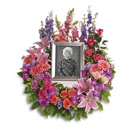 Conroy's Florist & Flower Delivery Mission Viejo - Preserve cherished memories in your heart with this beautiful and delicate floral wreath. It's an ideal choice to encircle a framed photograph of your loved one.

This arrangement features a rich variety of flowers, including roses, carnations, pink gerberas, oriental lilies, snapdragons, purple orchids, and asters, all complemented by the soothing lavender delphinium. Green button spray chrysanthemums add exquisite accents to this arrangement. Please keep in mind that this arrangement does not include a picture frame.

Orientation: One-Sided
