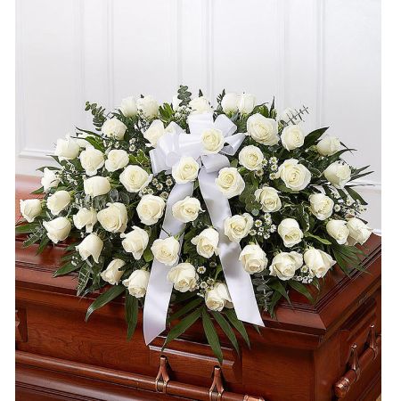 Conroy's Florist & Flower Delivery Mission Viejo - The precious moments spent with loved ones are the moments we want to hold onto forever. Capture this sentiment with a timeless display of all white. Our half casket cover, crafted with care and artistry by our expert florists with over 50 snow white roses, white monte casino, and accented with a white satin ribbon, is an unforgettable way to commemorate a lifetime of shared loving experiences.