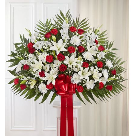 Conroy's Florist & Flower Delivery Mission Viejo - Love can help keep us going after a difficult loss. Sometimes this emotion is best expressed through a beautiful floral statement. Crafted by our expert florists, this traditional standing basket arrangement is filled with an array of red and white blooms, offering heartfelt condolences when words alone aren’t enough.