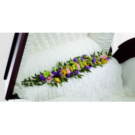 Conroy's Florist & Flower Delivery Mission Viejo - The Trail of Flowers Casket Adornment is a gorgeous accent piece that offers an extra touch of floral beauty at their memorial service. Green hydrangea, pink spray roses, yellow freesia, lavender larkspur and yellow button poms are arranged to bedeck the inner lining of the casket creating a soft and elegant look that perfectly commemorates the life of the deceased. Approximately 40"W x 6"D.